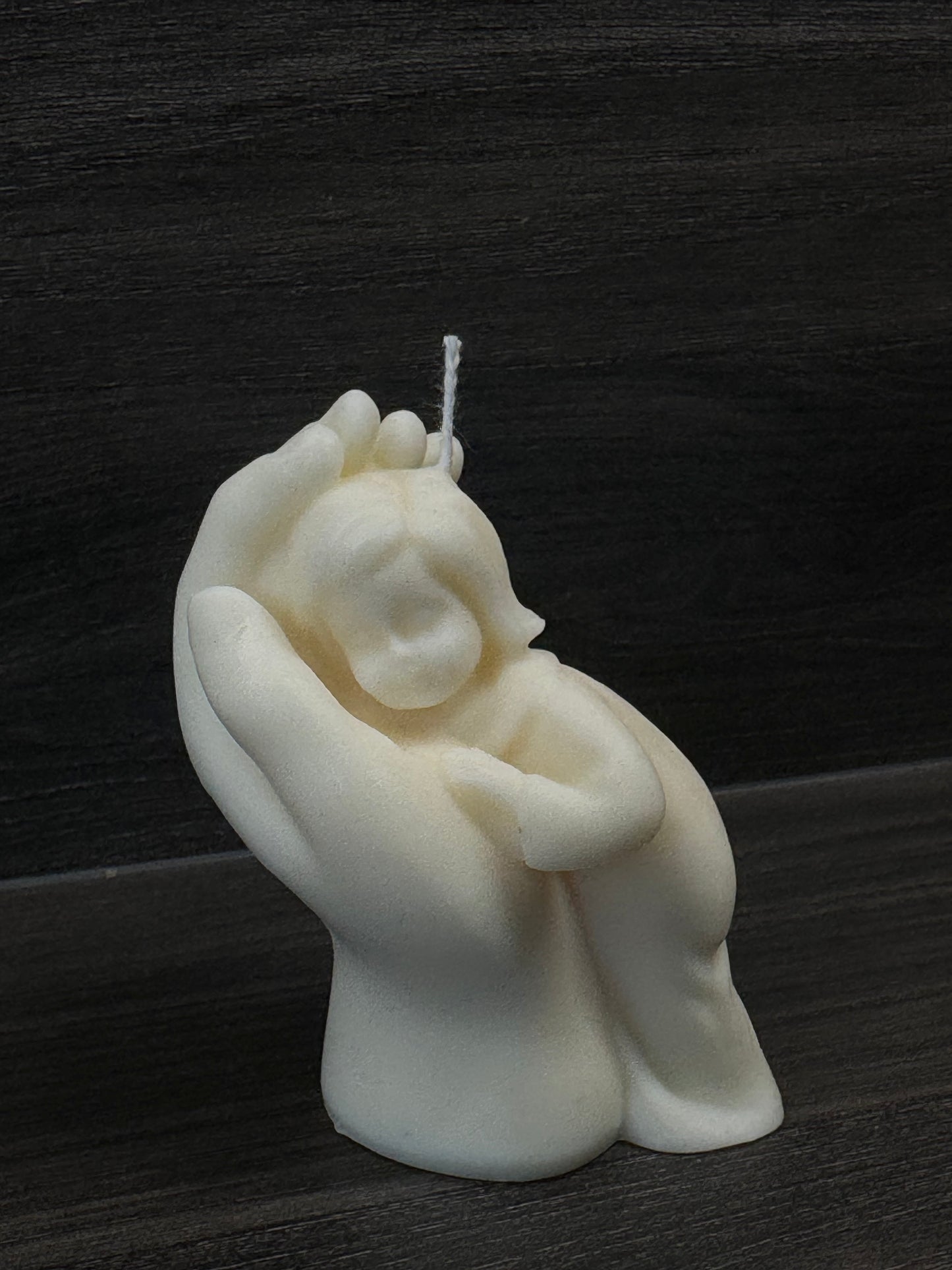 child on hand candle